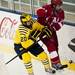 Michigan sophomore center Travis Lynch checks Miami sophomore defenseman Garrett Kennedy on Saturday. Michigan lost 4-3. Daniel Brenner I AnnArbor.com